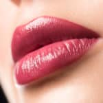 Closeup of beautiful sexy plump woman lips with lipstick