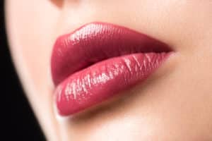 Closeup of beautiful sexy plump woman lips with lipstick