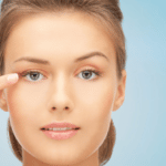 woman pointing finger to her eye