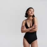 asian woman wearing swimsuit posing with arms crossed