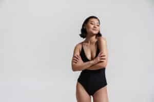 asian woman wearing swimsuit posing with arms crossed