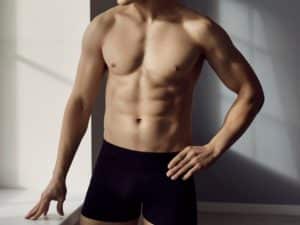 male model with athletic body wearing comfortable black cotton underpants standing