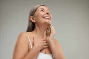 Smiling mature woman with beautiful neck after neck lift