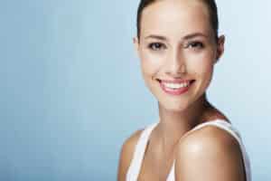 Woman smiling with glowing skin after hydrafacial treatment