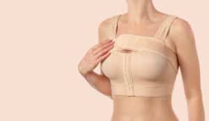 Woman wearing compression bra to help heal from surgery