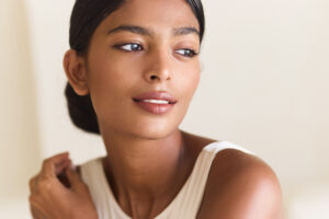 Woman with smooth, hydrated-looking facial and neck skin, highlighting areas that may be treated with Restylane Skinboosters.